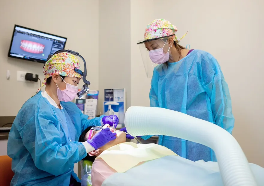 Green Dentistry team performing a mercury-safe SMART amalgam removal with protective gowns and high-volume suction in Alexandria, VA