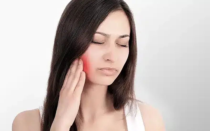 Person with jaw discomfort, representing TMJ and jaw pain care at Green Dentistry in Alexandria, VA